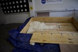 Wooden Box Covered in Blue Tarp