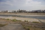 River Flowing by Industrial Landscape