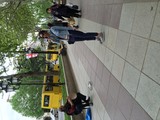 Street Musician and Passersby on Tbilisi Boulevard