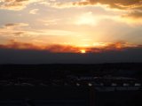 City Sunset with Clouds and Sun