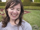 Woman Laughing Joyfully in a Formal Garden