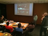 Conference gathering with laptops and projection screen