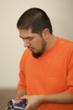 Orange Shirted Man Captures the Moment