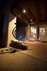 Blue Spiral Sculpture at Night in Adobe Courtyard
