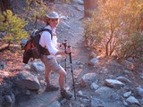 Smiling Hiker on Rocky Mountain Trail at Sunset