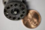 A Penny and a Bronze Object Up Close
