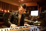 Leather-clad Musician Strikes the Right Key on His Keyboard
