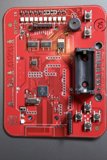 Red Circuit Board with Electronic Device Attached