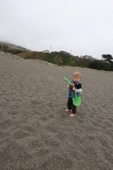 Barefoot Toddler Explores Foggy Pacific Beach