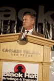 Man in Suit Delivers Speech at Plywood Podium