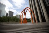 Orange Arch Against Urban Skyline