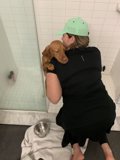 A Woman and her Canine Companion Take a Shower