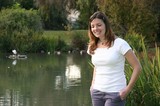 Smiling Woman by a Serene Park Pond
