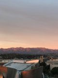 Sun setting over the urban mountains and buildings of LA