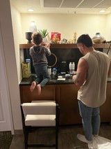 Father and Son Making Coffee Together in Modern Kitchen