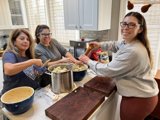 Three Women Preparing a Delicious Meal in the Kitchen