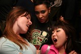 Three Women Caught in Intense Party Moment