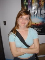 Young Woman Posing Casually in Front of Movie Poster