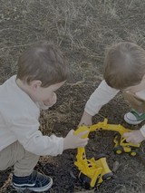 Two Children Playing with Yellow Toy Excavator