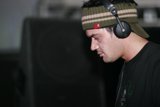 Black Shirted Man Listening to Music
