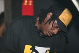 Black Shirted Performer in Baseball Cap