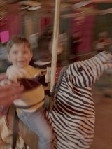 Children Enjoying Blurry Carousel Ride Motion