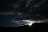 Lunar Glimpse Behind the Cumulus Clouds
