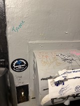 Graffiti and Stickers in Urban Bathroom Corner
