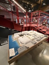 Architectural Model Display in Red Industrial Gallery Space