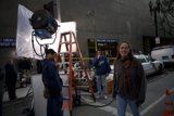 Woman Posing in a Hoodie in Front of a Camera