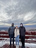 Snowy Deck View with Three People