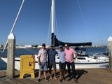 Four Men and their Sailboat at the Waterfront