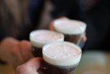 Three People Enjoying Their Drinks