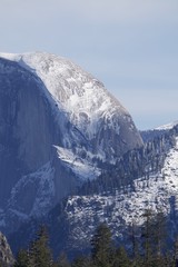 Half Dome's Majestic Snow-Covered Granite Face in Winter