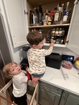Two Young Brothers Exploring Kitchen Pantry Together