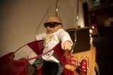 Stylish Doll on a Red Bike