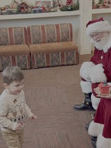 Child Meets Santa Claus at Christmas Gathering