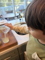 Child Making Fresh Lemonade in Modern Kitchen