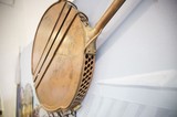 Vintage Brass Bed Warmer Mounted on White Wall
