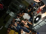 Nightclub DJ Entertains a Crowded Room
