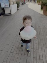 Young Child Enjoying Cotton Candy Outdoors
