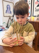 Young Boy Enjoying Iced Drink with Bamboo Straws