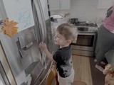 Toddler Exploring Kitchen Refrigerator at Home