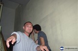 Two Men Posing in Front of Wall