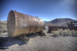Desolate Tank Amidst the Gravel Road