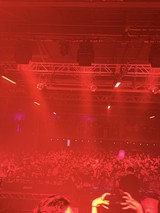 Red-Lit Concert Crowd Under Stage Lighting Rig