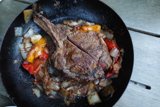 sizzling steak with colorful peppers and onions