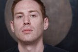 Redheaded Man in Black Shirt