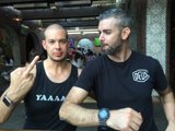 Two Men in Black Shirts Working Out Together