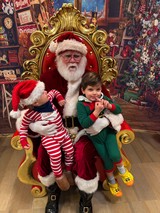 Two Children Visit Santa in His Ornate Golden Throne